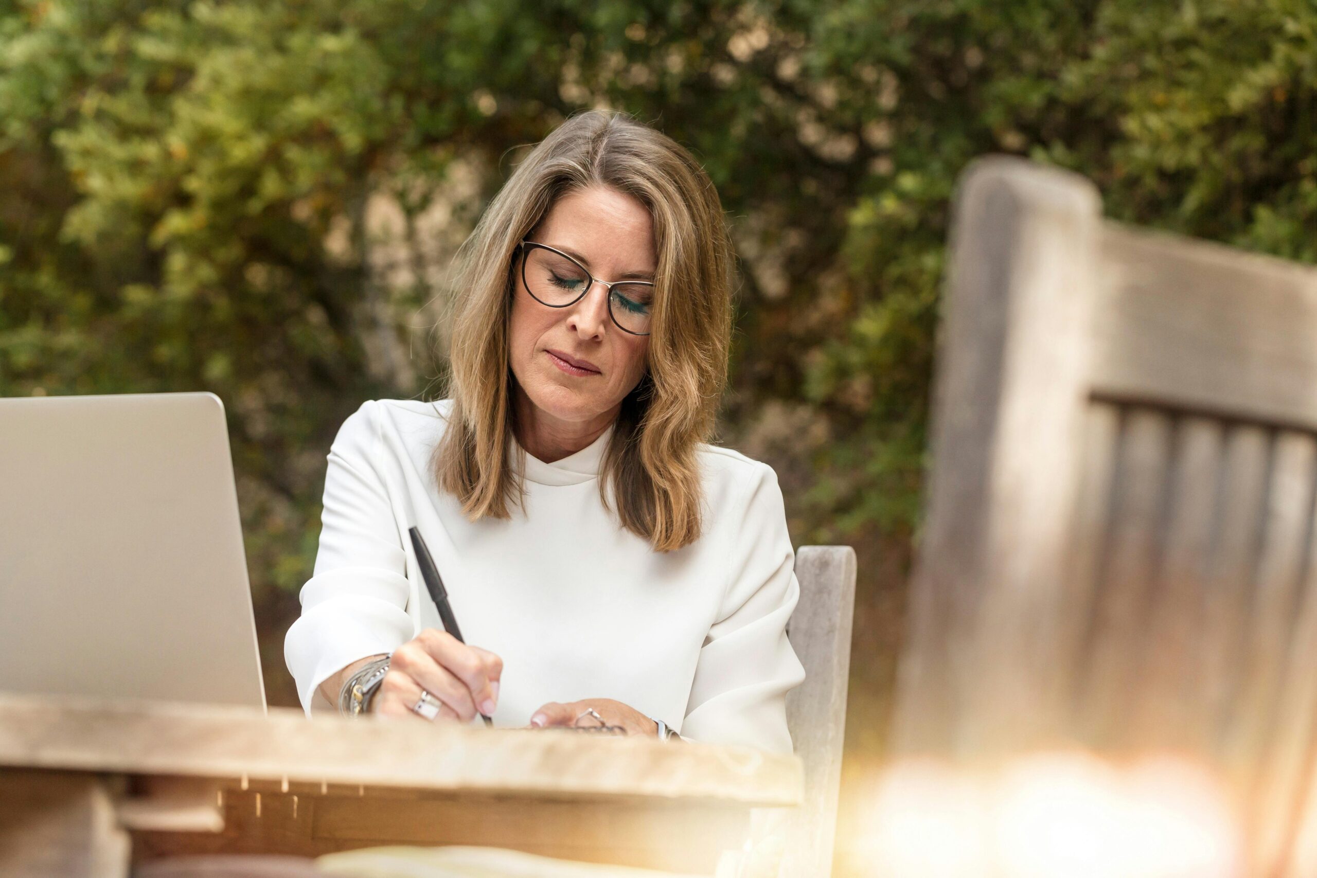 A woman studies health and hormone replacement therapy on her laptop.