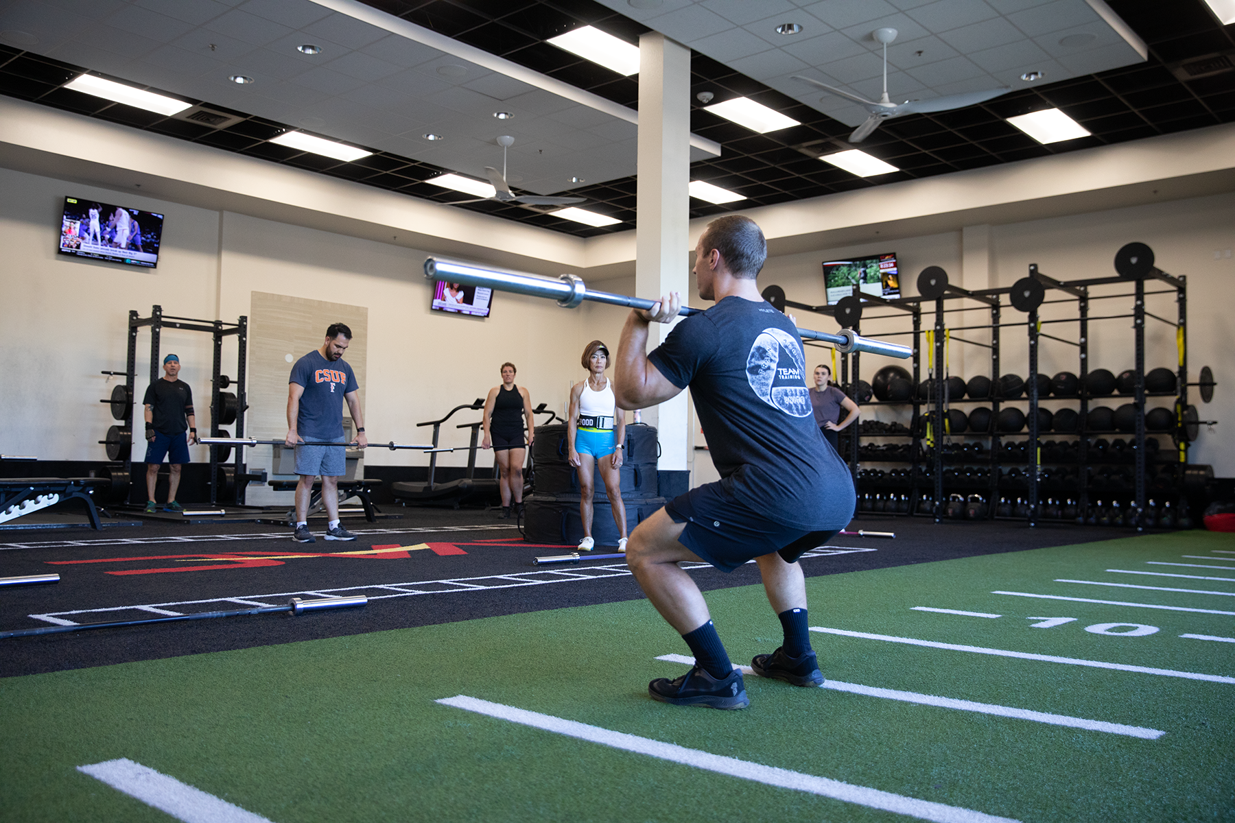 A Crossfift instructor at LVAC teaches the class how to perform an exercise.