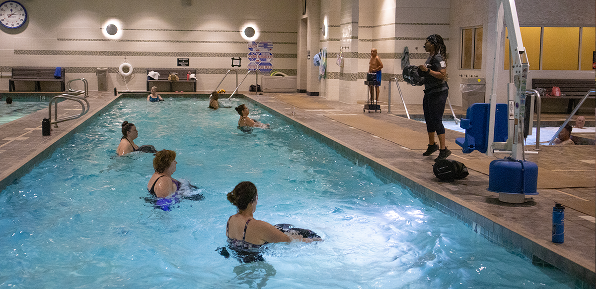 LVAC Members participate in an aqua class by dragging weighted bags in the water.