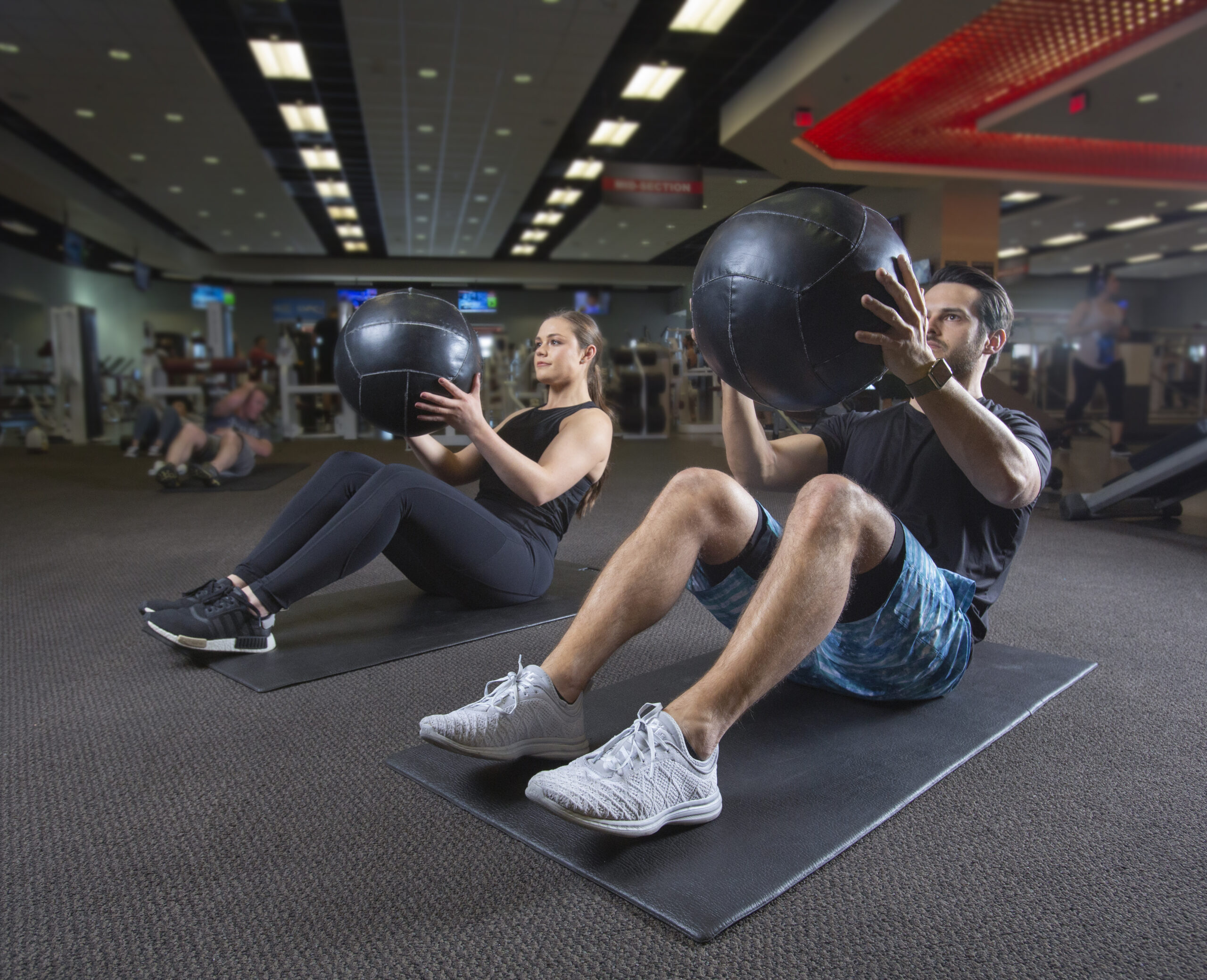 A man and woman work out together at LVAC and support one another.