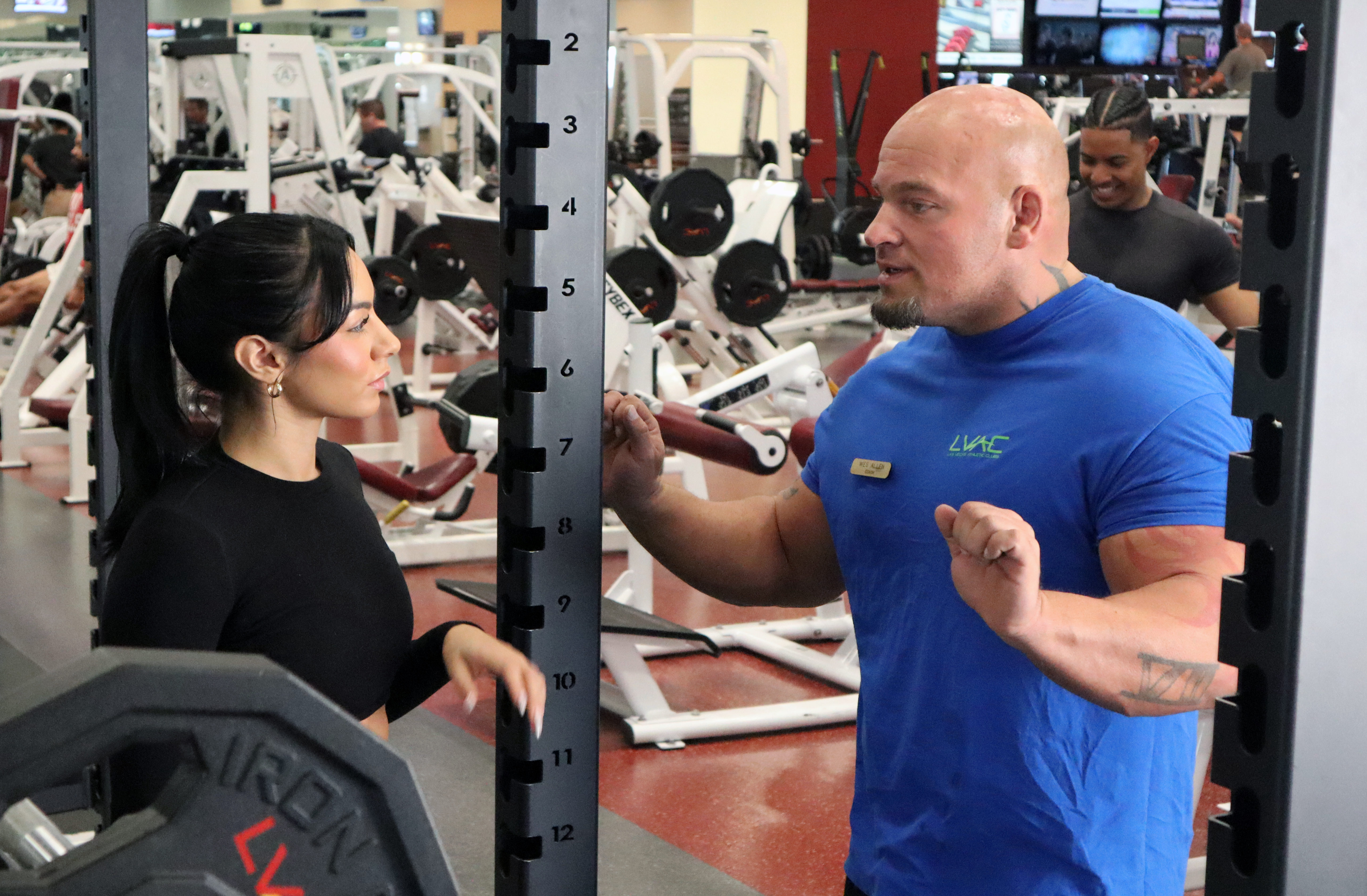 A woman consults with a personal trainer at LVAC.